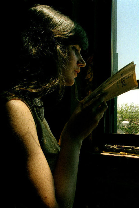 NYC actor, Annika Franklin, reads Petit Prince by a window.